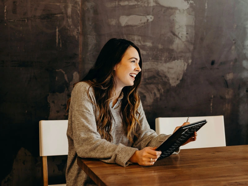 Woman smiling with a tablet in her hands
