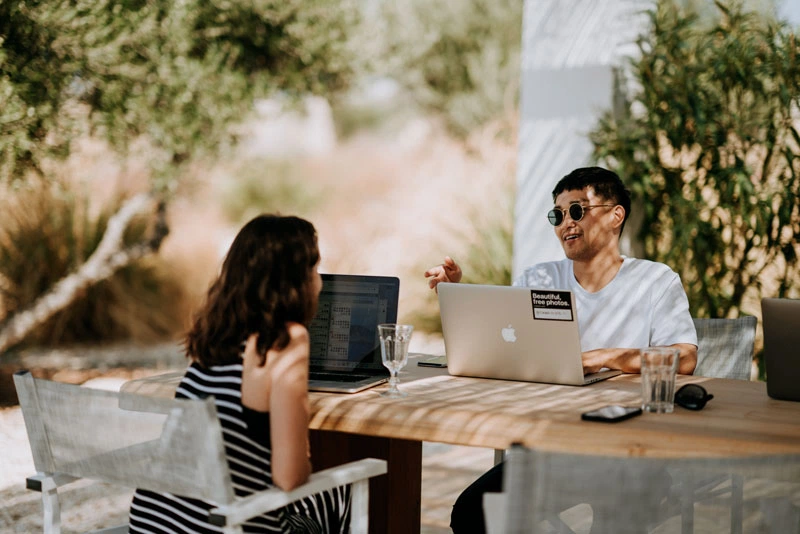 A man and woman are sitting at a tabl