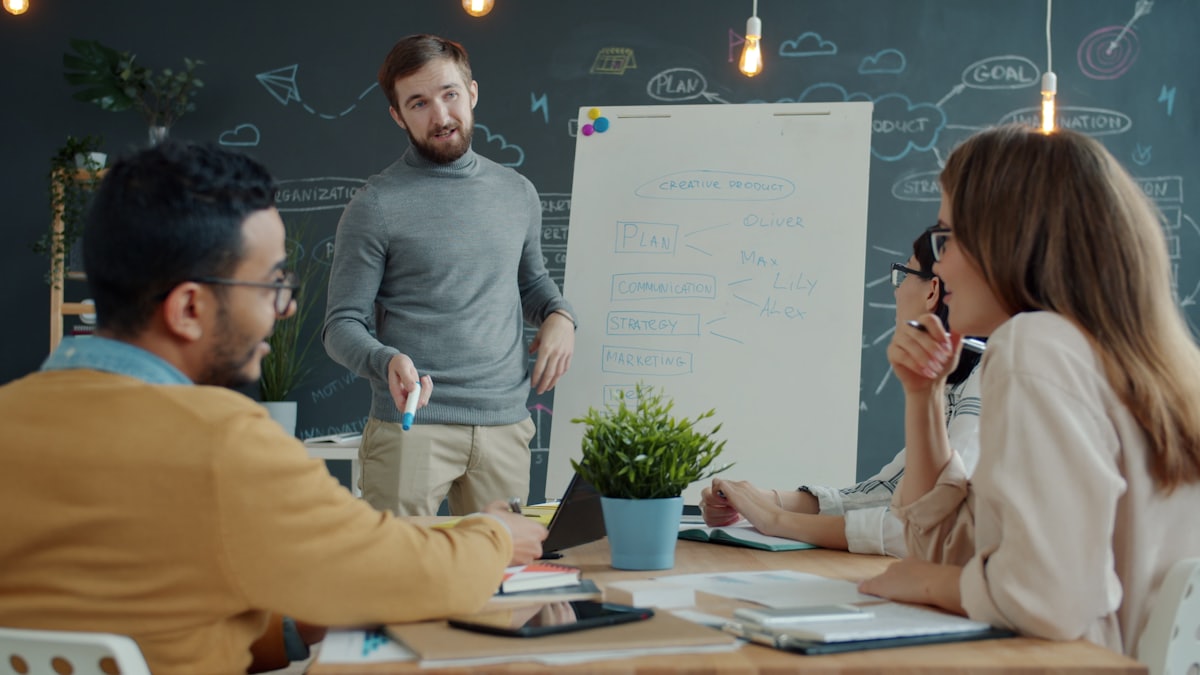 A team planning strategy at a whiteboard