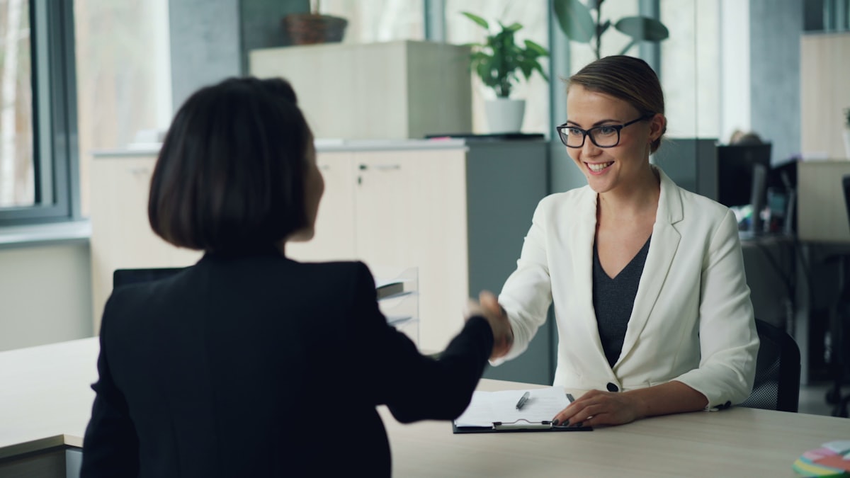 A candidate and a hiring manager shaking hands