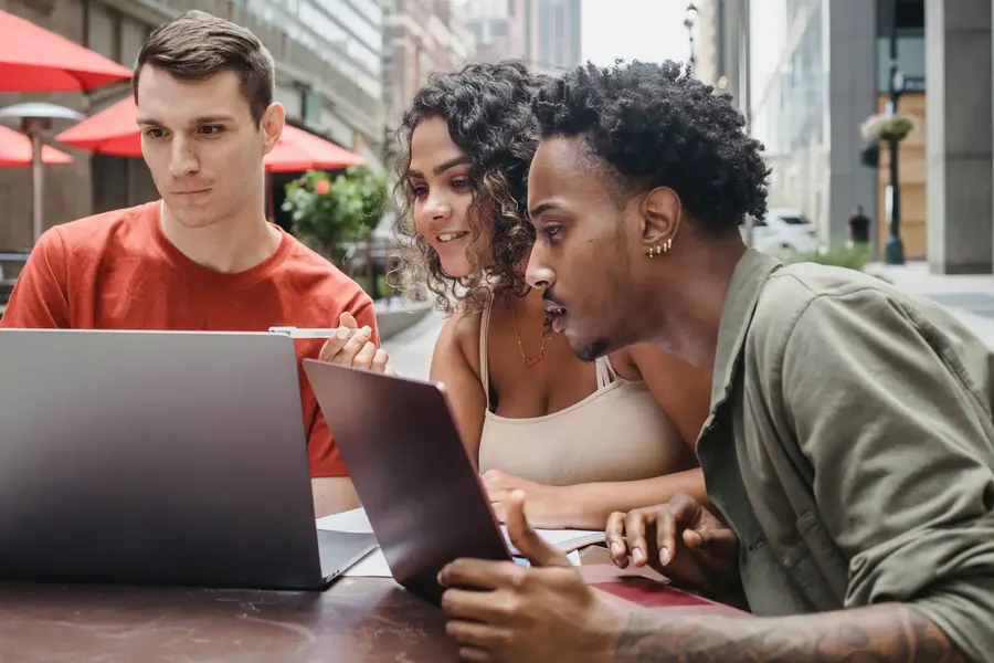 Developers looking into a laptop